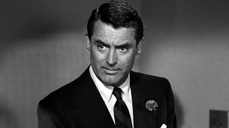 Dick Nugent wearing a black suit and tie in 