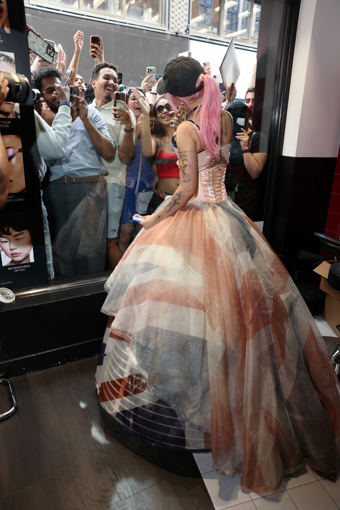 Doja Cat wears a corset and baseball cap to MAC activation in London