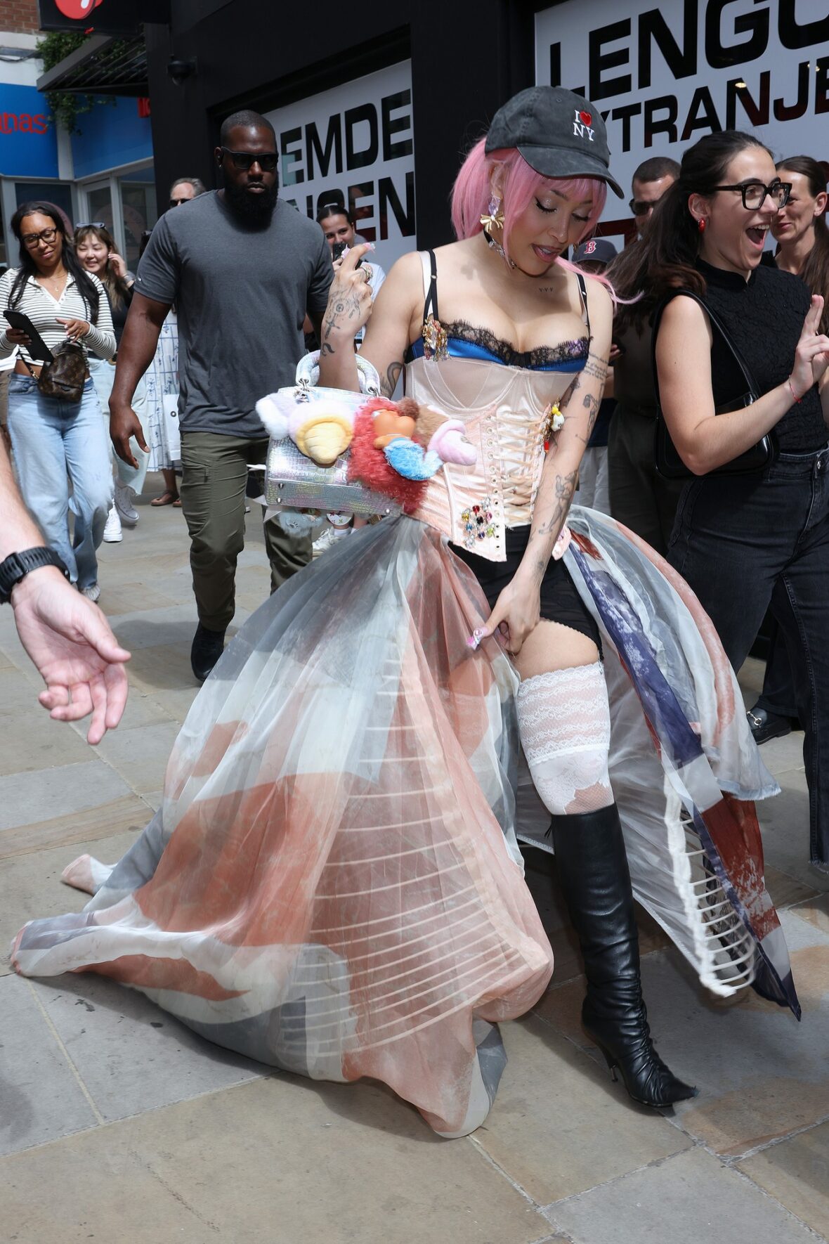 Doja Cat wears a corset and baseball cap to MAC activation in London