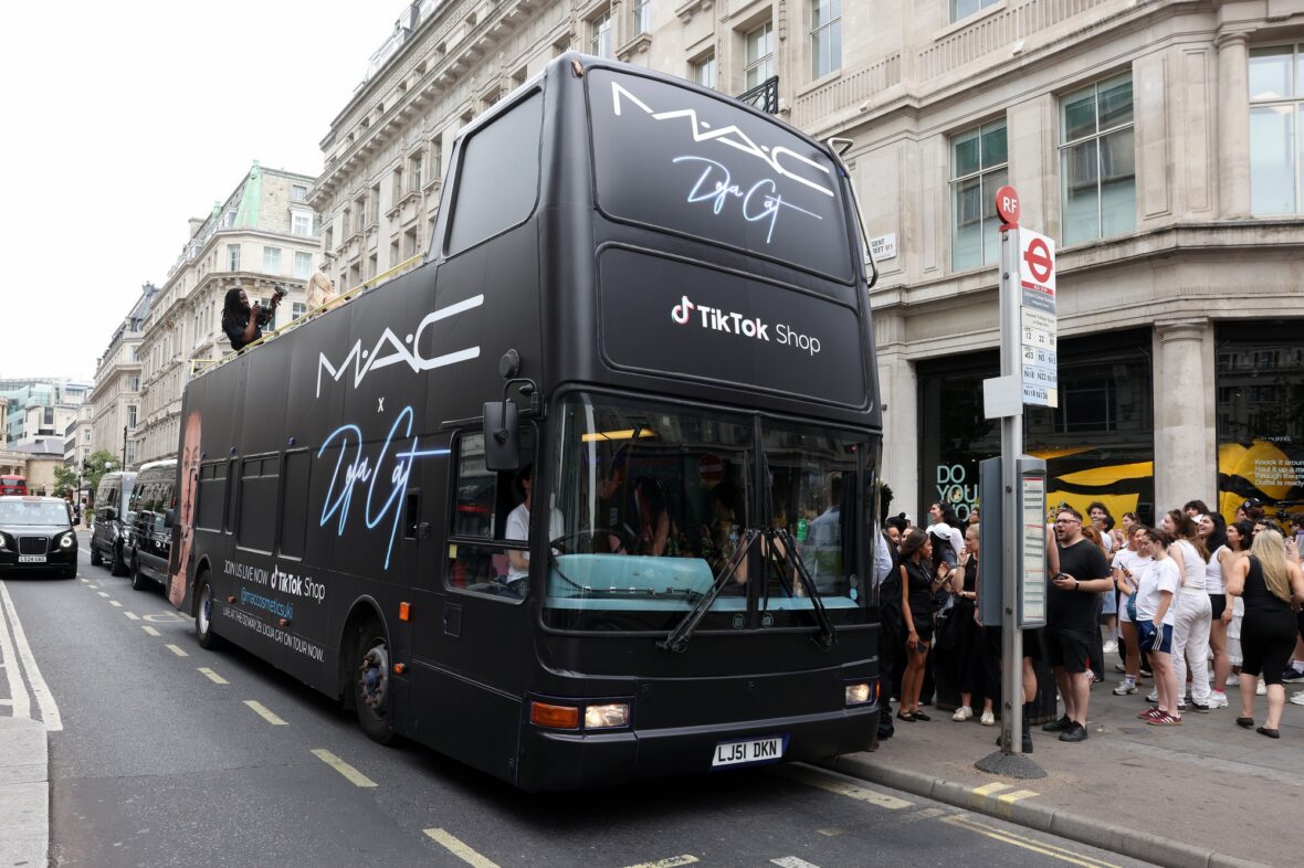 Doja Cat wears a corset and baseball cap to MAC activation in London