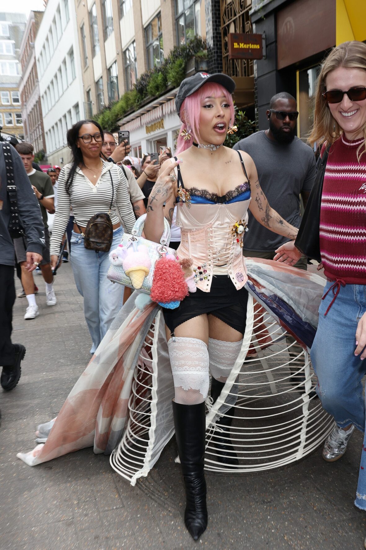 Doja Cat wears a corset and baseball cap to MAC activation in London