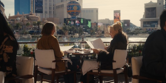 Hannah Einbinder and Jean Smart seated at a restaurant with the Vegas Strip in the background in 'Hacks' 