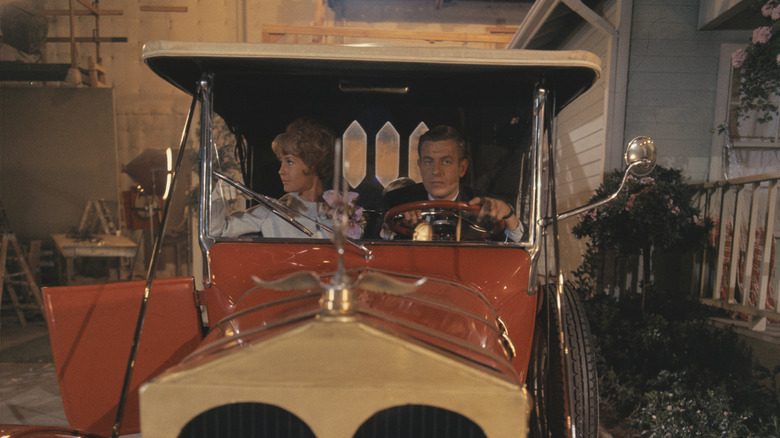 Barbara Crabtree (Maggie Pierce) and Dave Crabtree (Jerry Van Dyke) sitting in red 1928 car in 