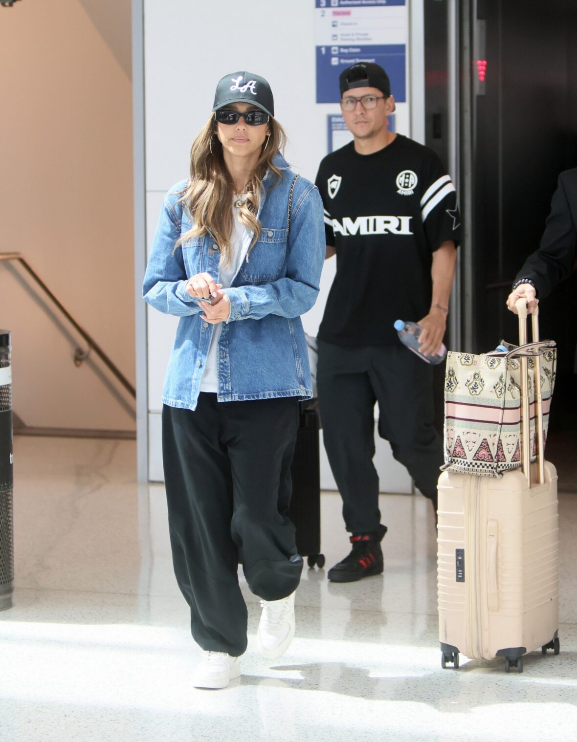 Jessica Alba and Danny Ramirez walking together at LAX