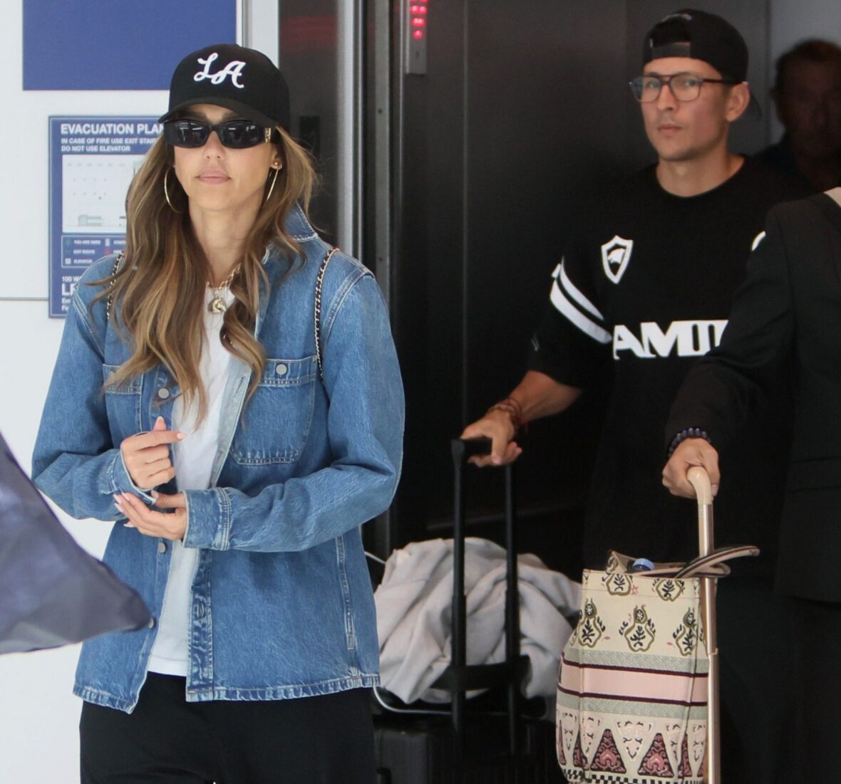 Jessica Alba and Danny Ramirez walking together at LAX
