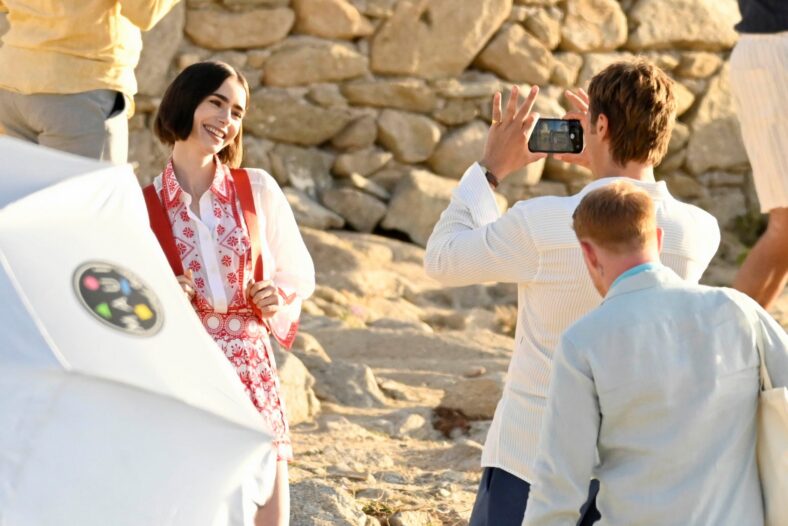 Lucas Bravo and Lily Collins on set