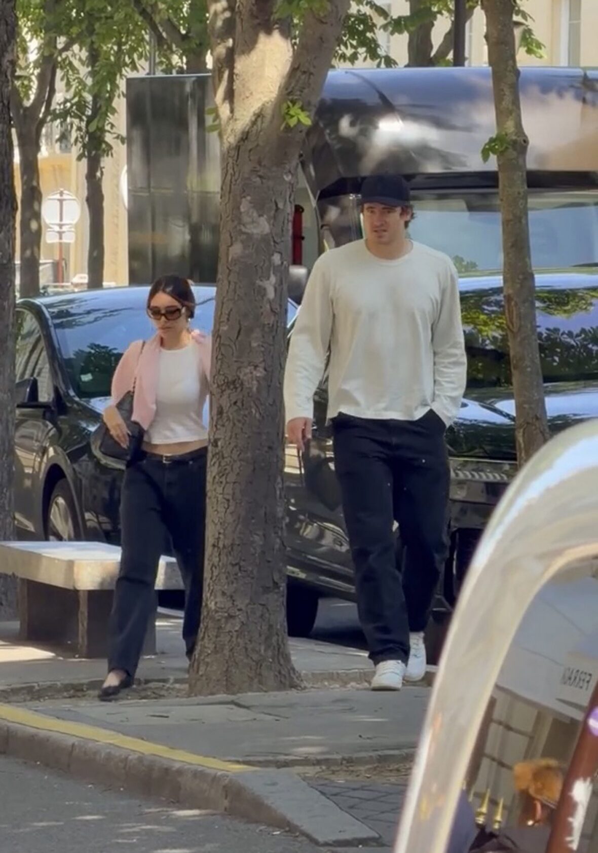 Justin Herbert and Madison Beer walk side-by-side outdoors