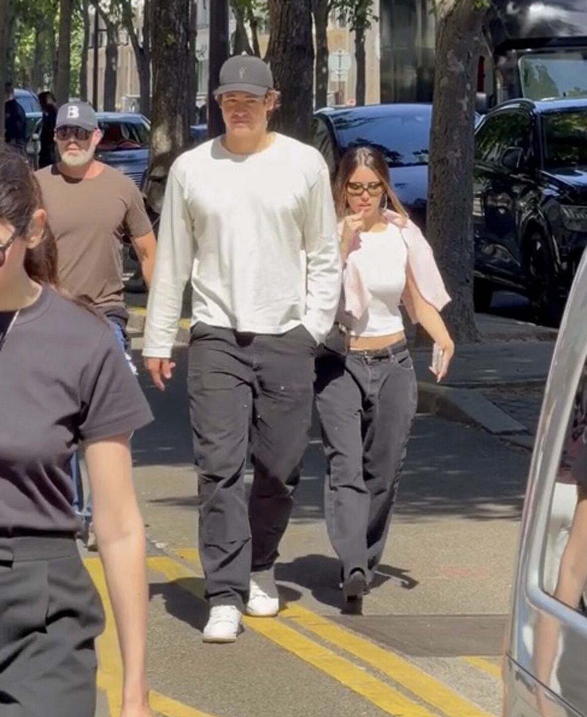 Justin Herbert and Madison Beer walk side-by-side outdoors