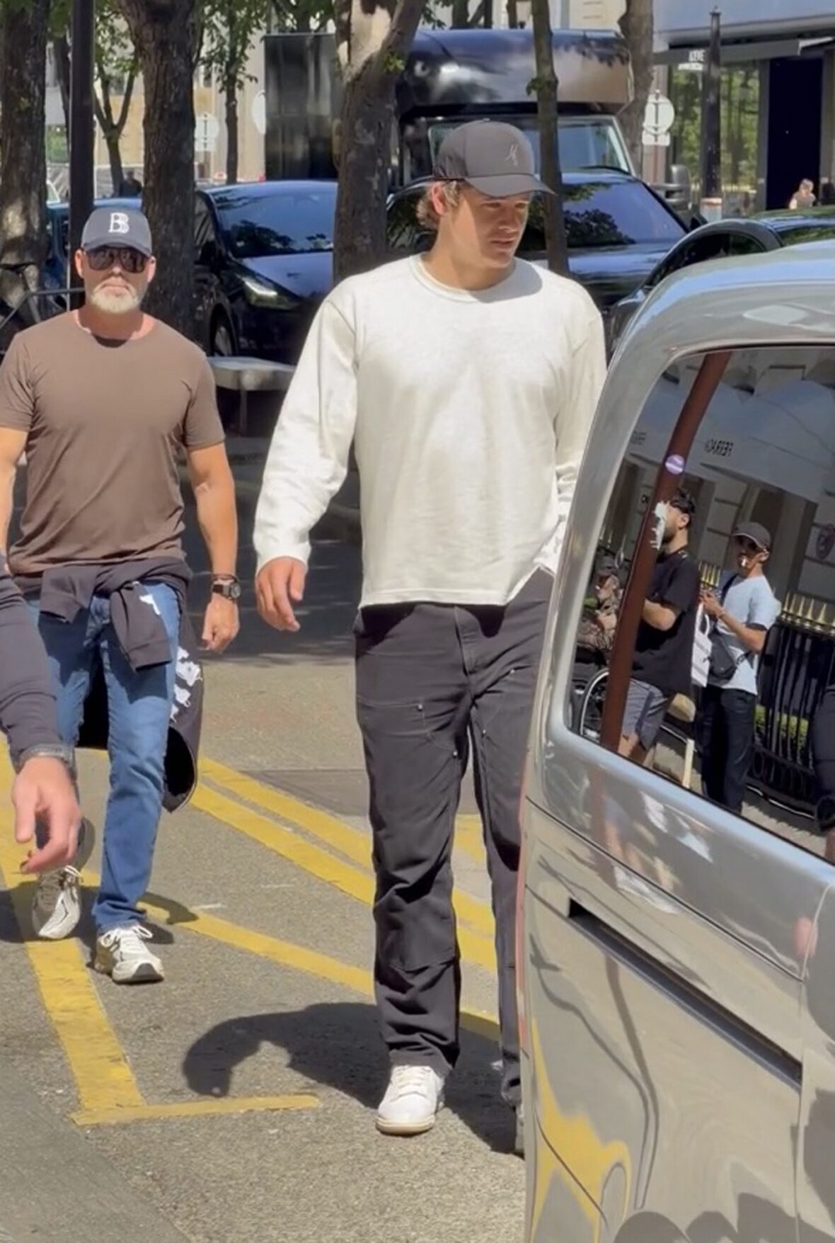 Justin Herbert walks toward a car outdoors
