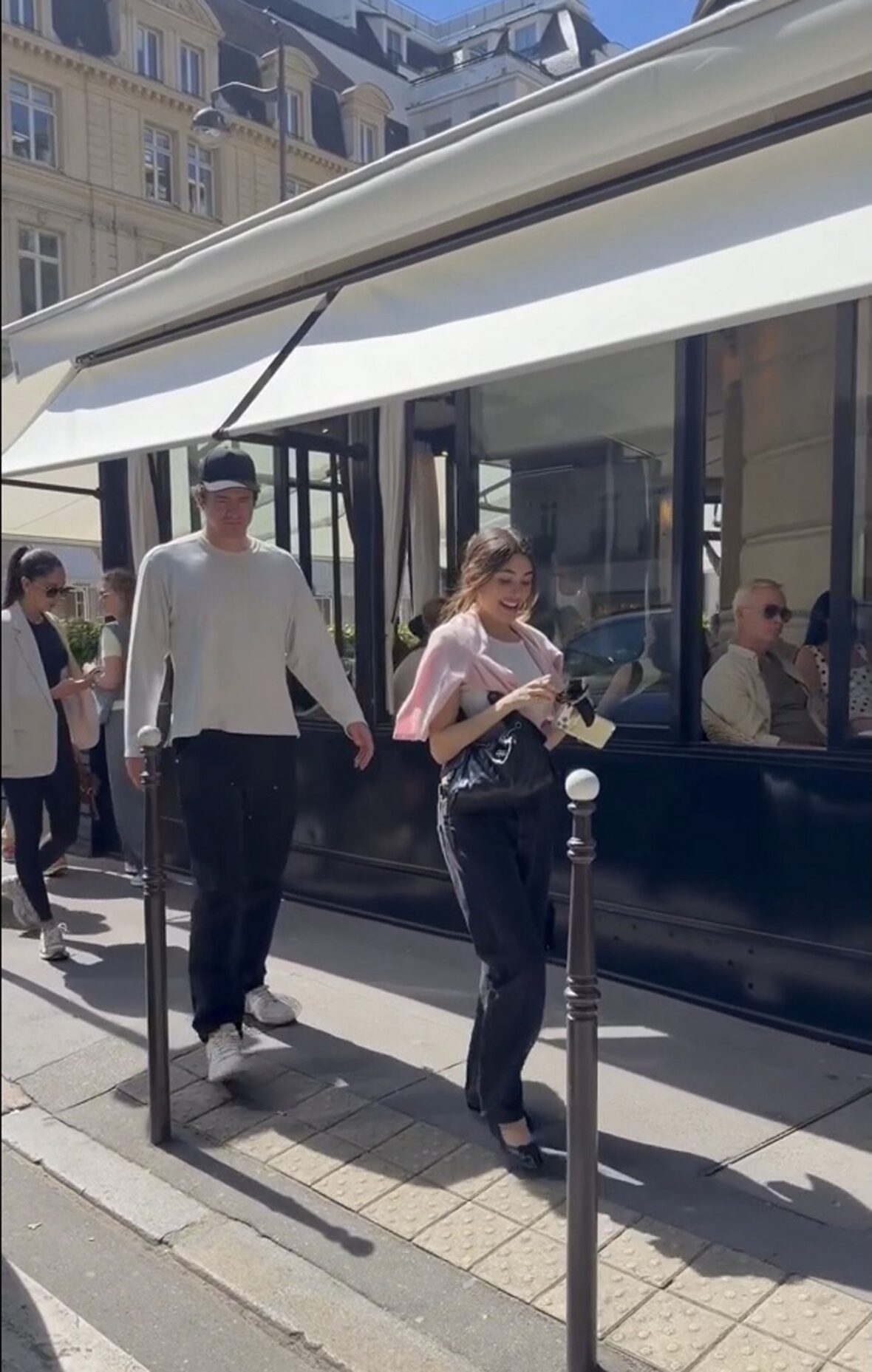 Justin Herbert and Madison Beer walk side-by-side outdoors