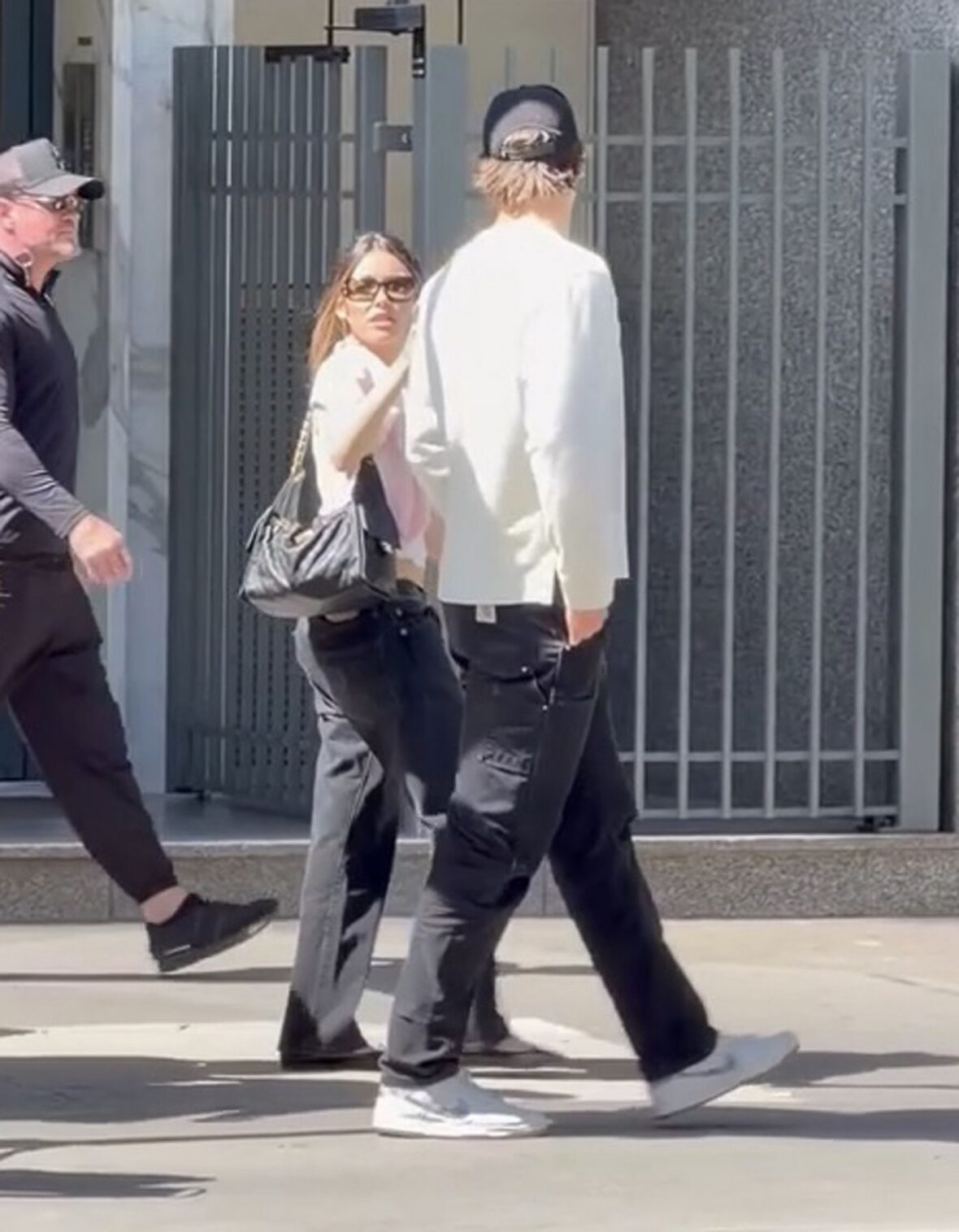 Justin Herbert and Madison Beer walk side-by-side outdoors