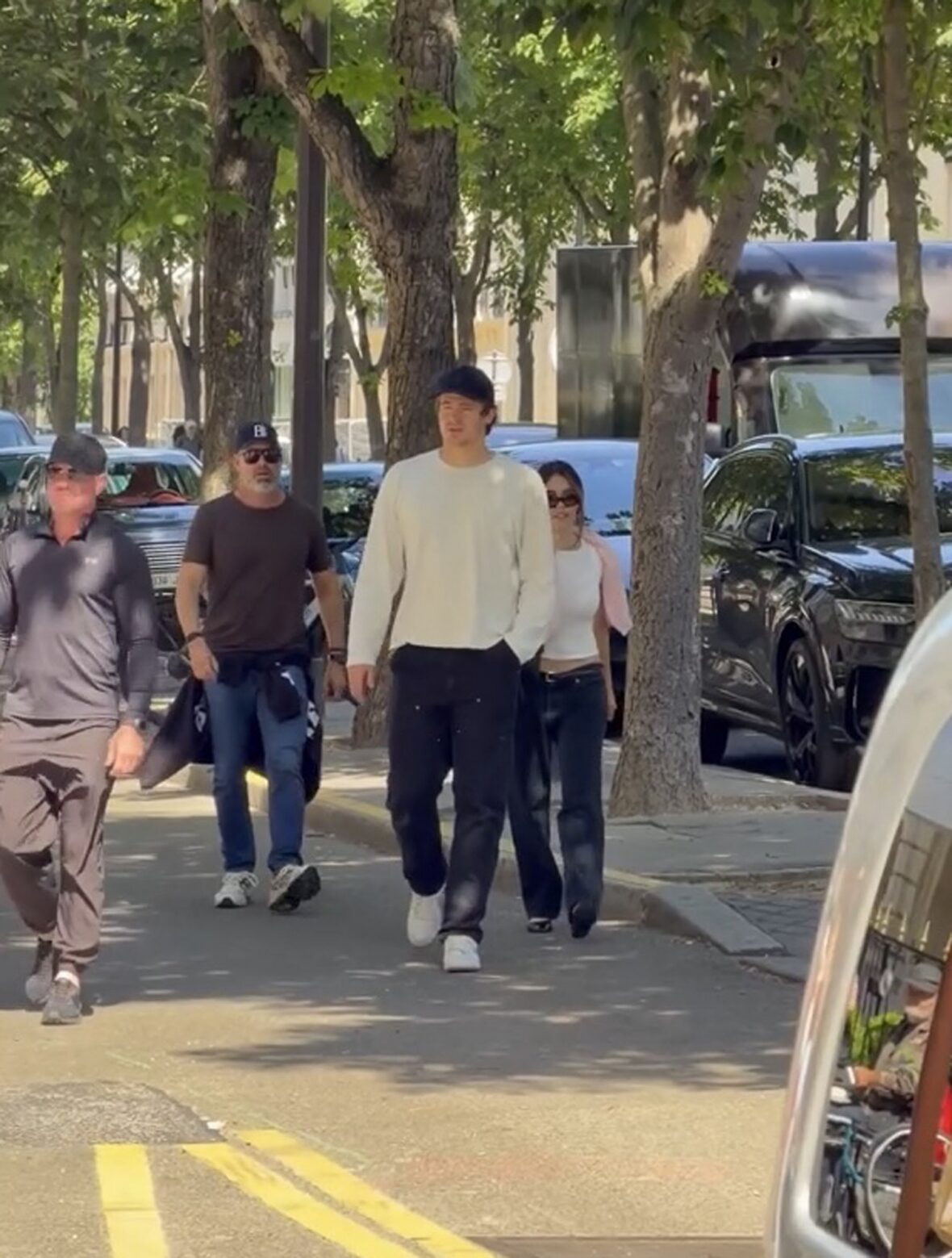 Justin Herbert and Madison Beer walk side-by-side outdoors