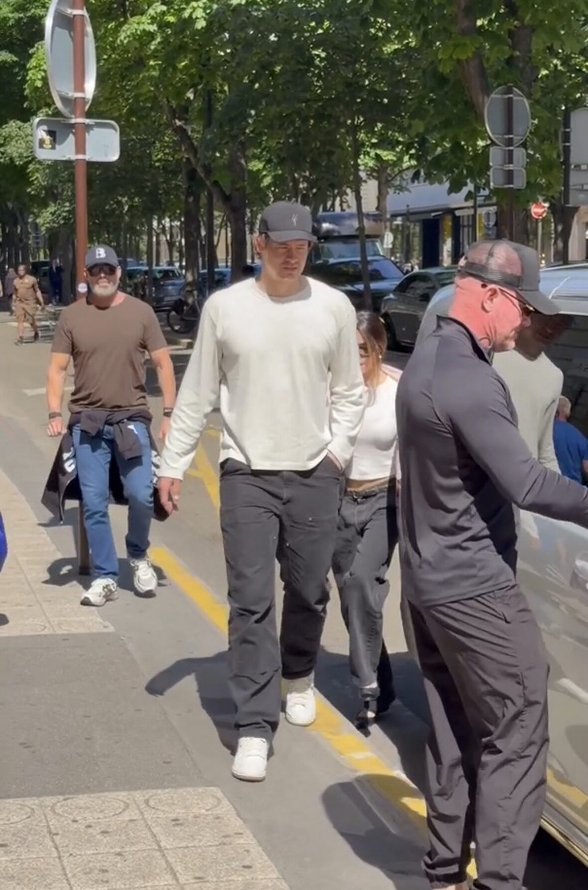 Justin Herbert and Madison Beer walk side-by-side outdoors