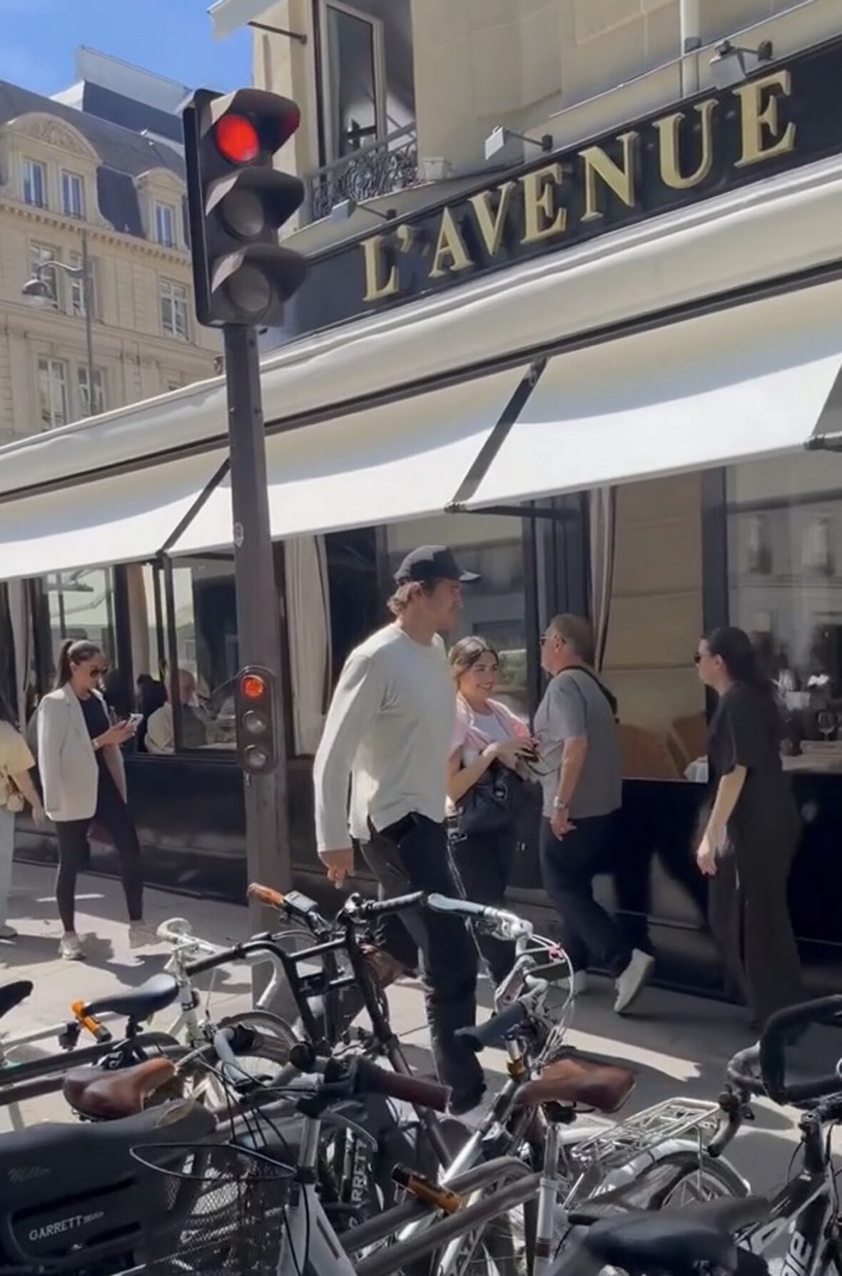 Justin Herbert and Madison Beer walk side-by-side outdoors