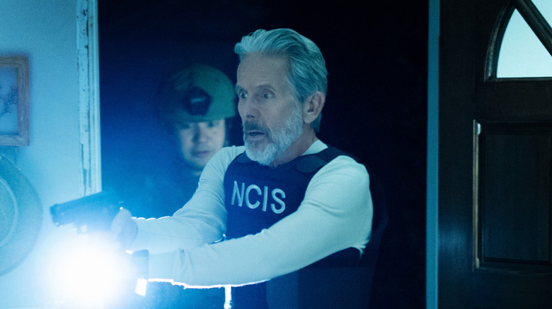 Alden Parker (Gary Cole) holding gun and flashlight, looking shocked, on 