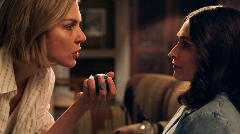 Carol Sturka holding a grenade facing Zosia in 