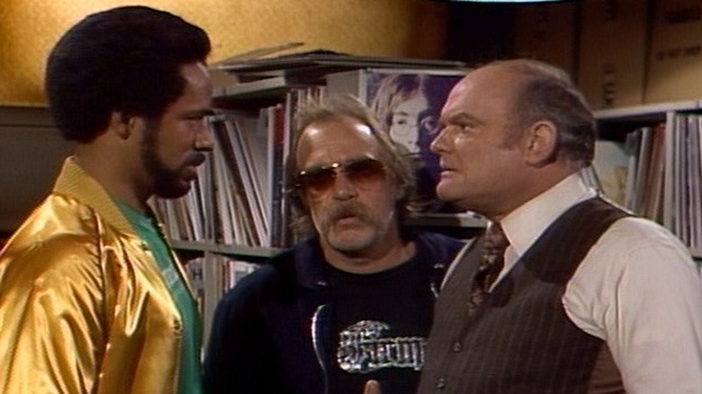 Venus Flytrap, Dr. Johnny Fever and Mr. Carlson meet in the record room at WKRP
