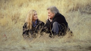 'The Madison' stars Michelle Pfeiffer as Stacy Clyburn and Kurt Russell as Preston Clyburn, shown here sitting in a golden field, smiling at each other