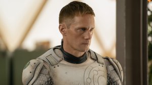 Alexander Skarsgård in 'Murderbot,' shown here with his mask off, armor on, staring determinedly to his left