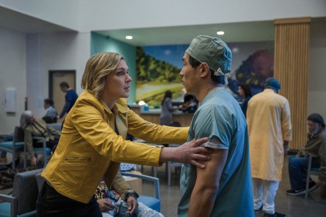 'Pluribus' stars Rhea Seehorn, shown here grabbing a doctor by the shoulders in a crowded waiting room