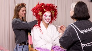 Makeup designers Alex Perrone and Ana Gabriela Quinonez making up actor Lisa Gilroy in a clown face and tangled wig in 'Very Important People'