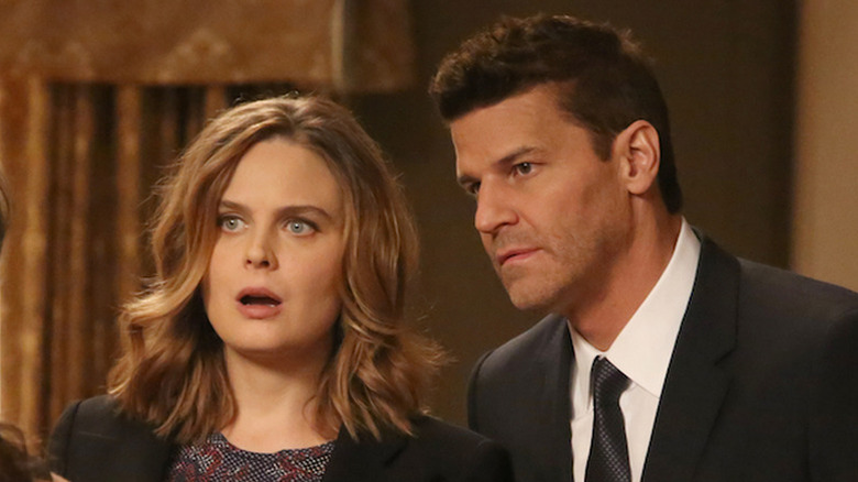 Brennan (Emily Deschanel) and Booth (David Boreanaz) standing next to each other on 