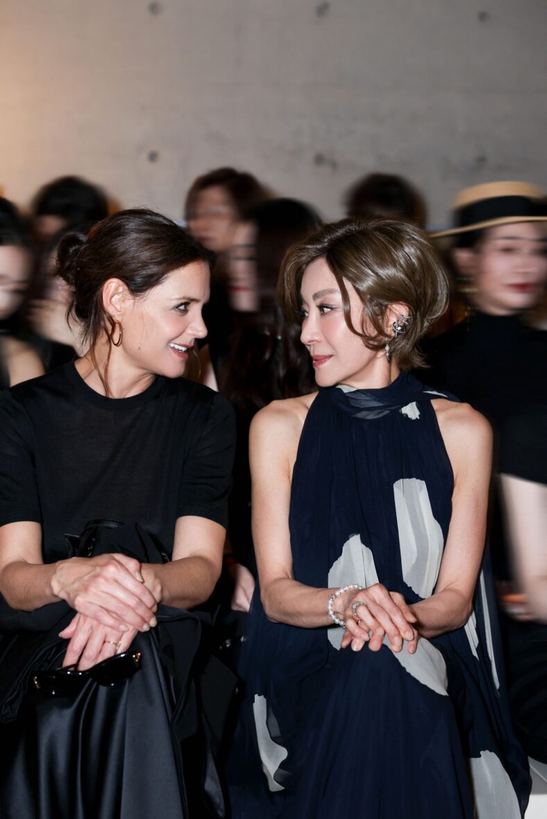 Katie Holmes and Michelle Yeoh smile at each other while sitting front row at Max Mara fashion show in Shanghai