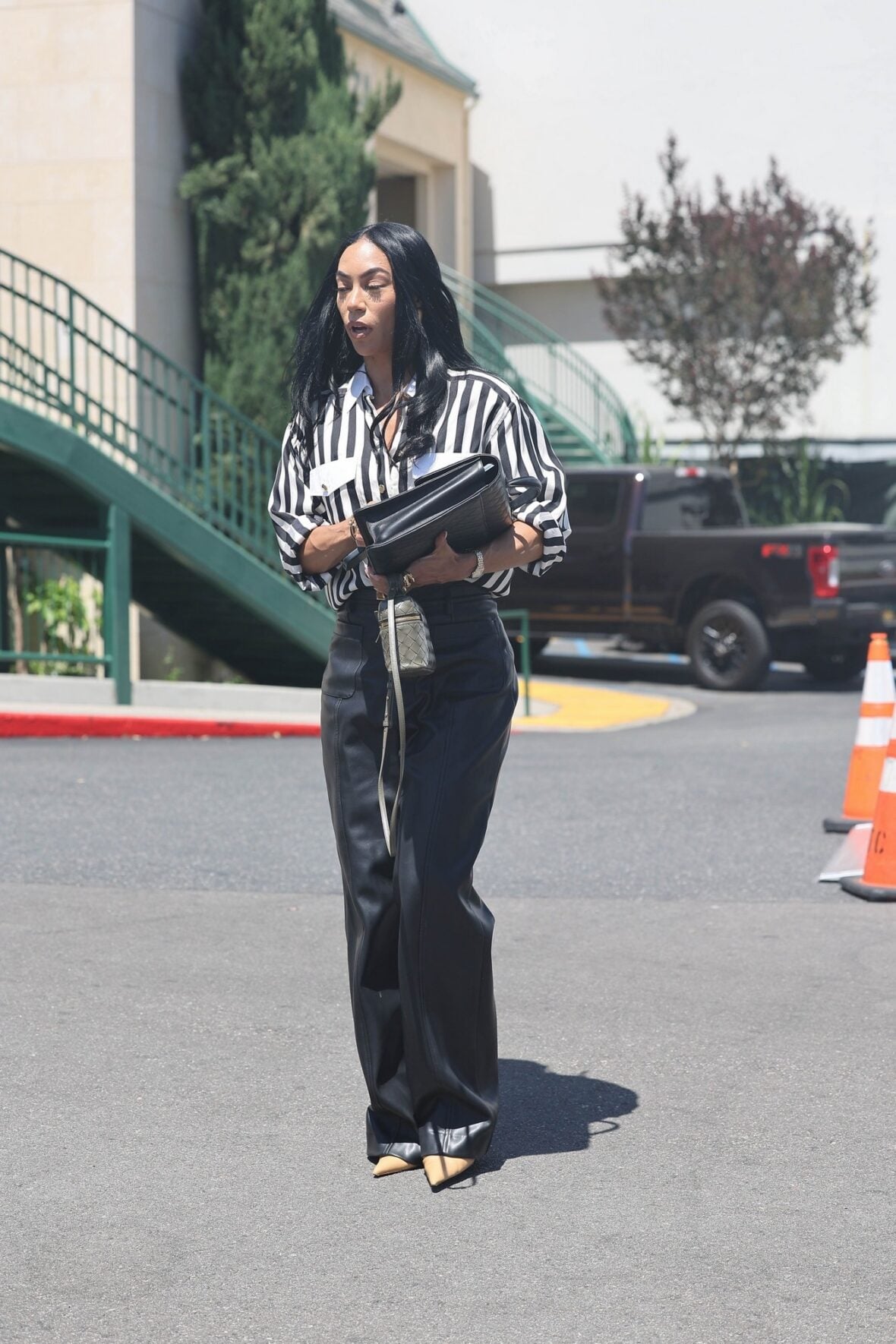 Sasha Lance leaving the Oppenheim Group office in LA