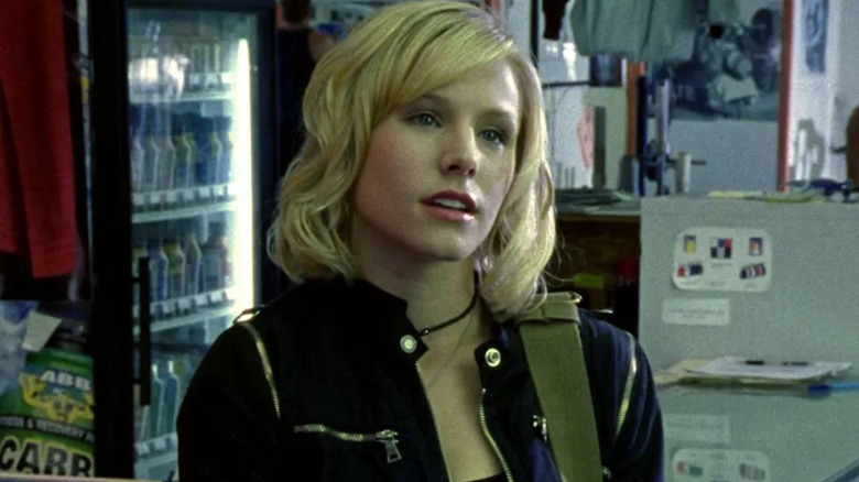Veronica Mars looking skeptically at someone off screen in front of a cooler