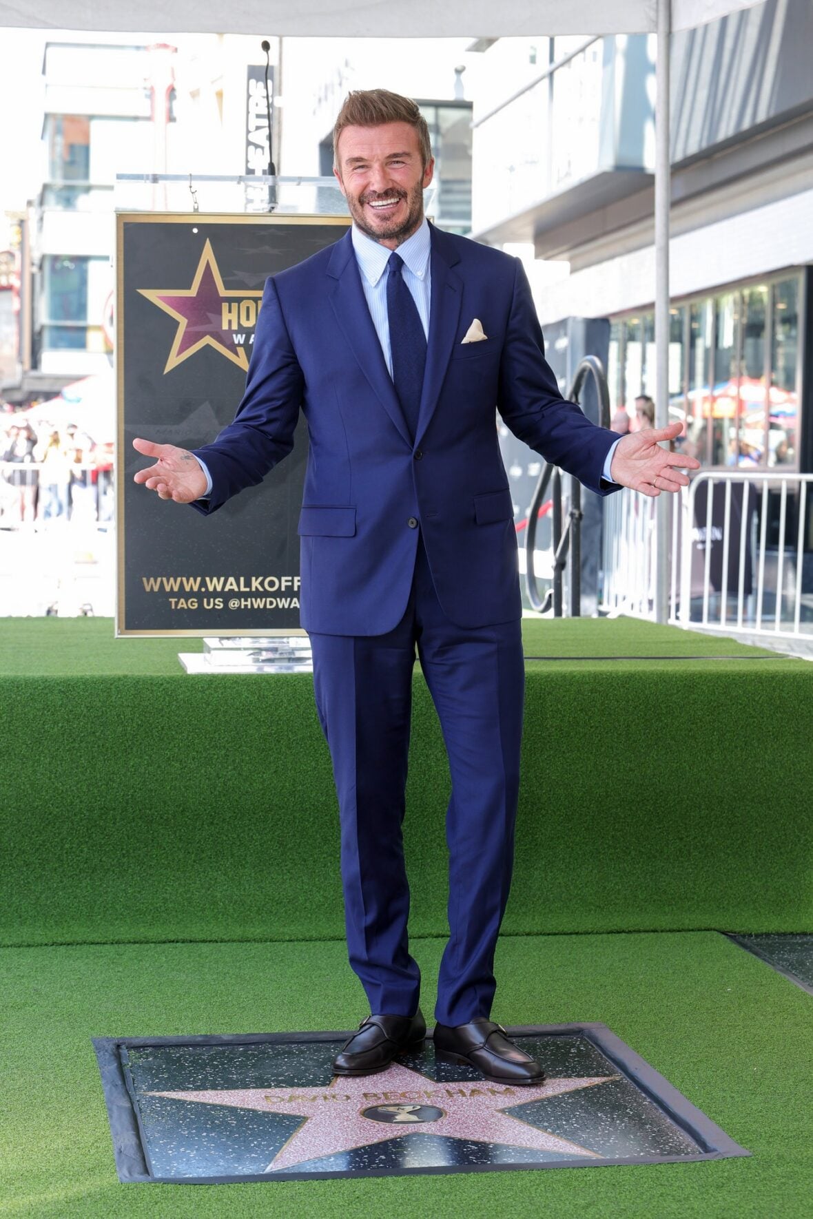 David Beckham poses with his star on the walk of fame