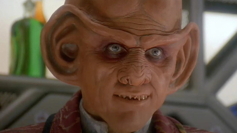 Quark smirking at someone off camera