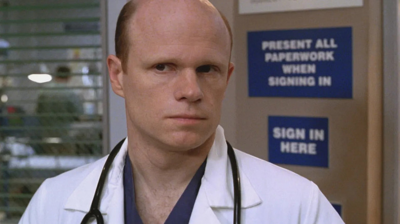 Dr. Robert Romano looking wary while standing in the ER with a stethoscope around his neck