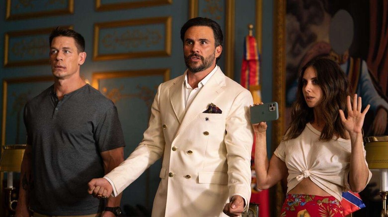 Mason (John Cena), Juan (Juan Pablo Raba) and Claire (Alison Brie) standing next to each other in 