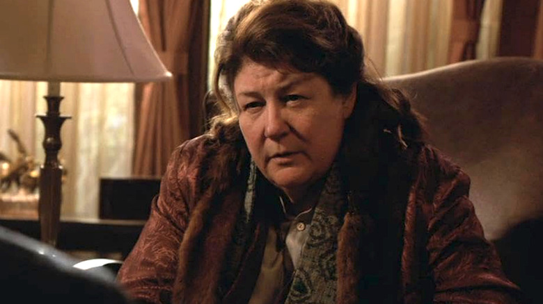 Mags Bennett sitting wearing a brown jacket in Justified