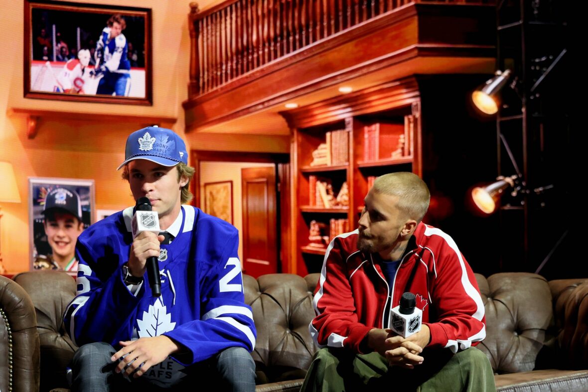 Gavin McKenna of Canada and singer Justin Bieber look on after McKenna was drafted by the Toronto Maple Leafs