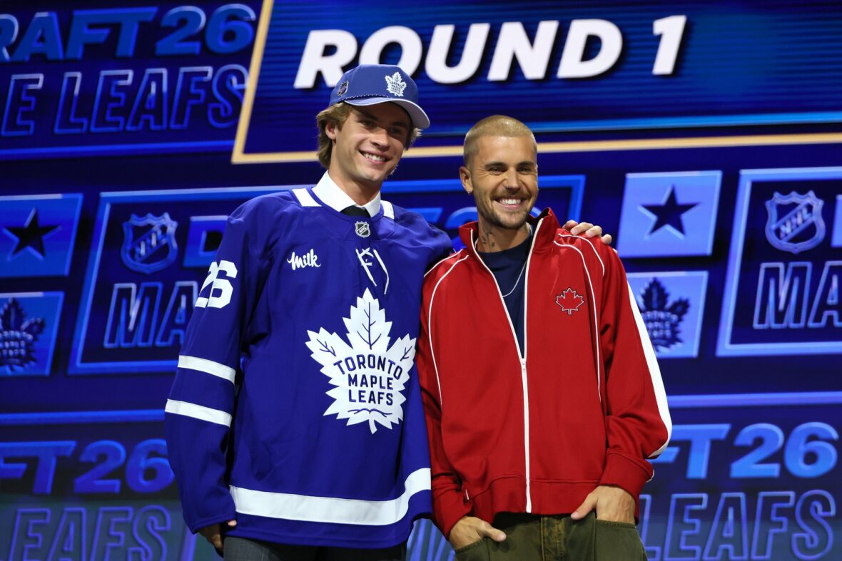 Gavin McKenna of Canada and singer Justin Bieber look on after McKenna was drafted by the Toronto Maple Leafs