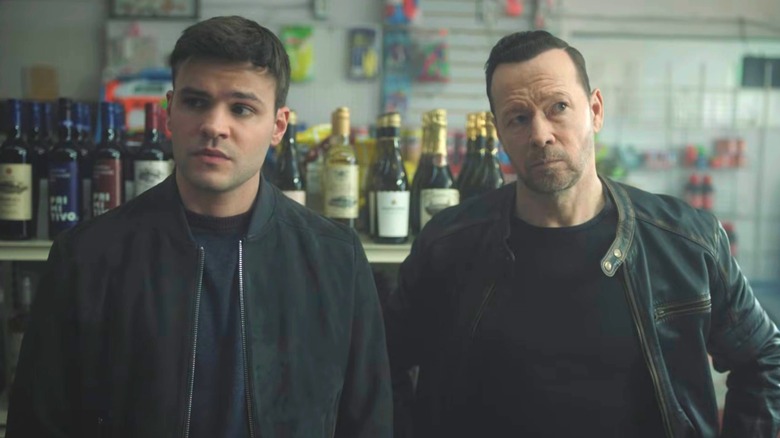 Danny Reagan and Sean Reagan standing next to each other in a liquor store