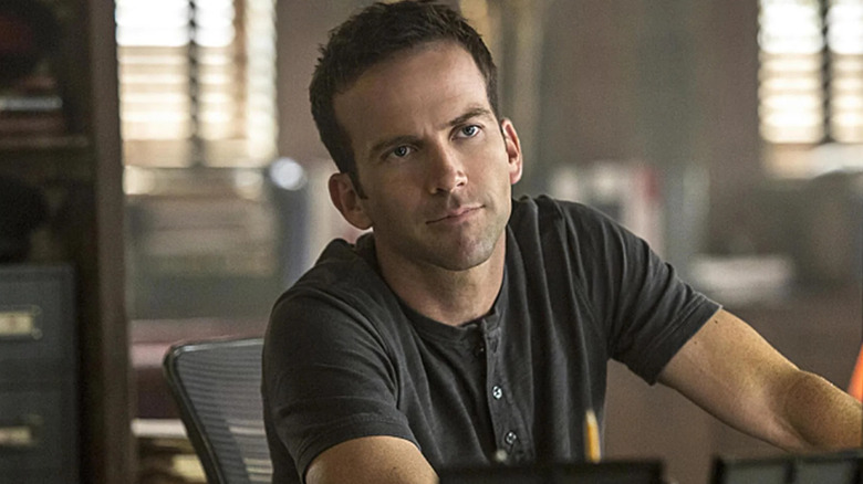 LaSalle (Lucas Black) sitting at his desk on 
