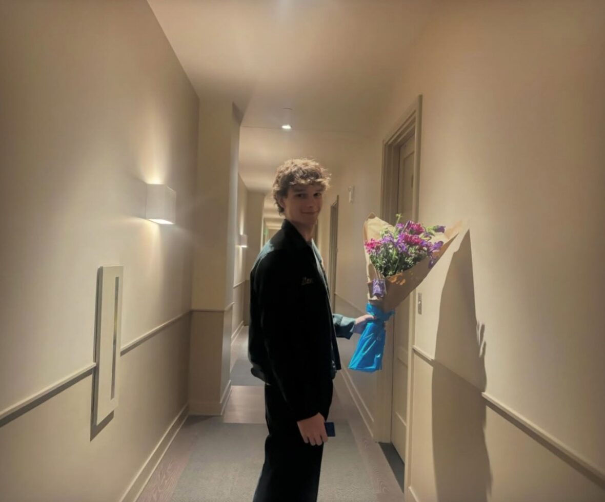 Mason Thames holding a bouquet of flowers
