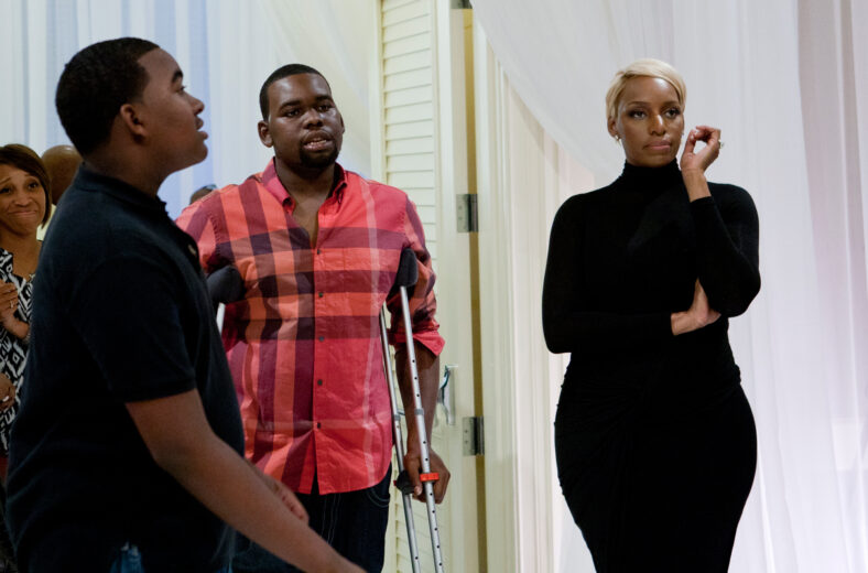 NeNe Leakes stands in a room with her two sons, during a scene from I Dream of NeNe.