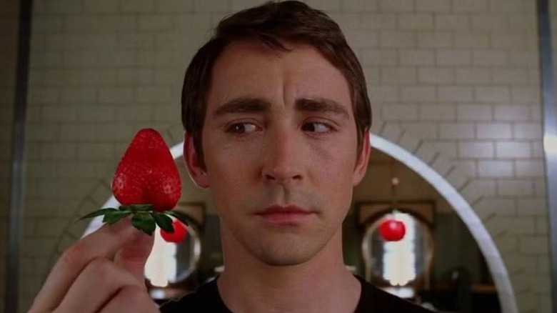 Ned (Lee Pace) holding a strawberry on 