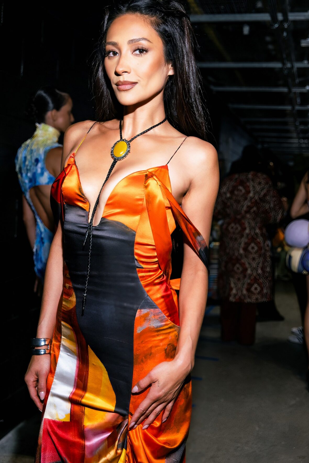 Shay Mitchell in an orange dress backstage