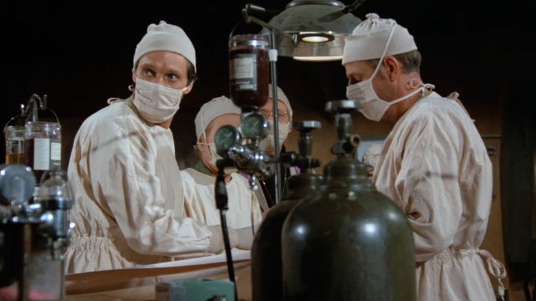 Hawkeye and Henry Blake operating on a soldier in M*A*S*H (1973)
