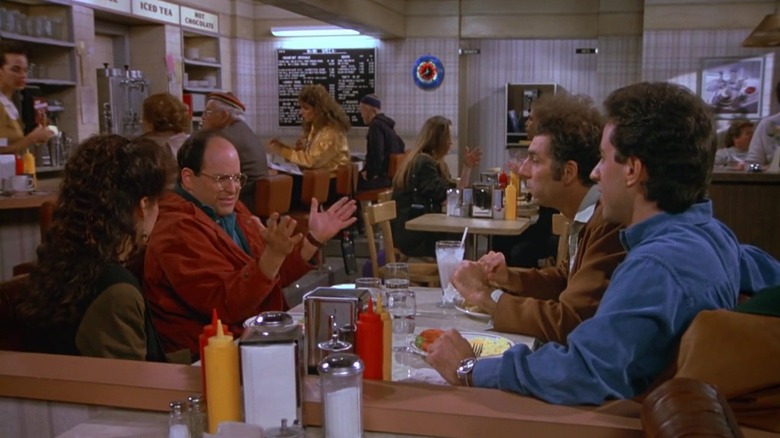 George talking to Elaine, Jerry, and Kramer in the diner in Seinfeld