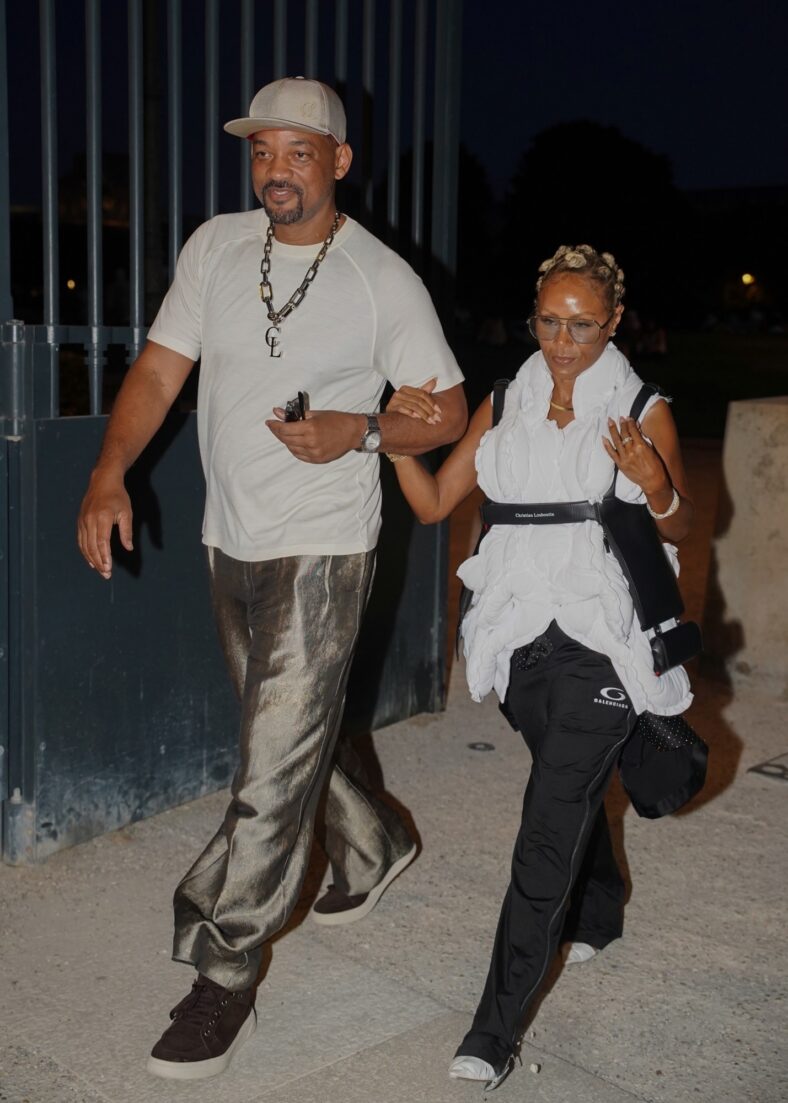 Will Smith smiles while walking arm-in-arm with Jada Pinkett Smith after a rare dinner outing in Paris.