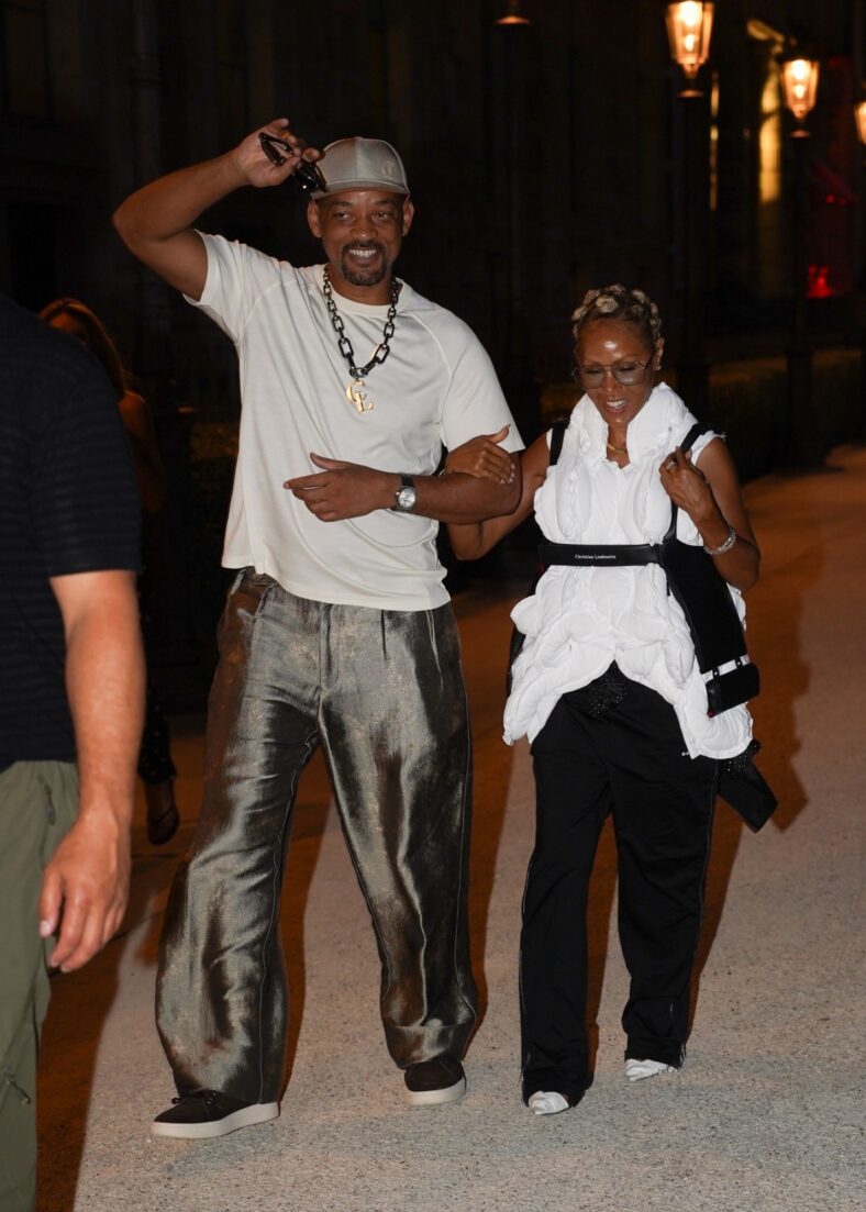 Will Smith smiles while walking arm-in-arm with Jada Pinkett Smith after a rare dinner outing in Paris.