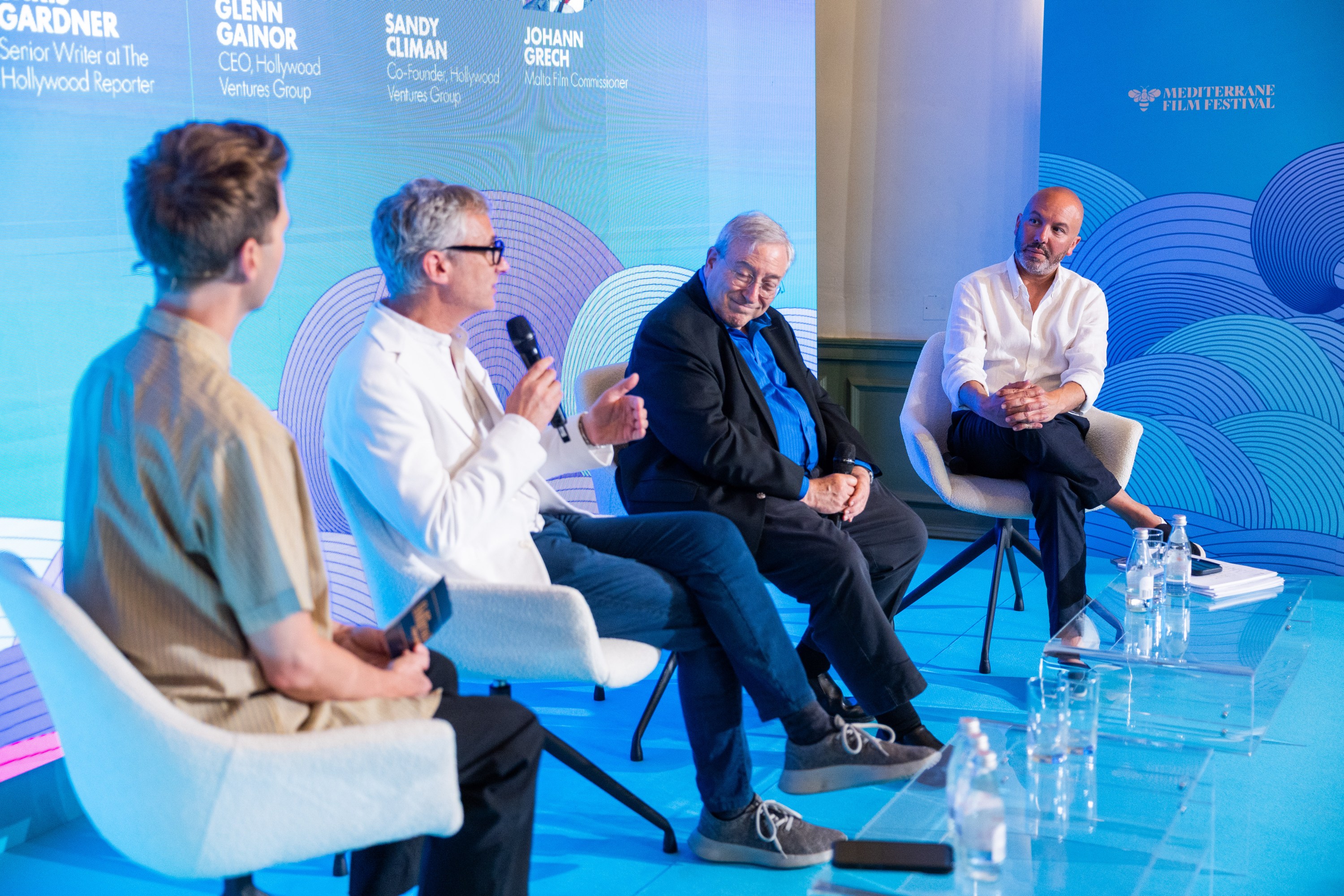 Johann Grech, far right, appears on stage with Hollywood Ventures Group’s Glenn Gainor and Sandy Climan during a panel titled “Building for Tomorrow” as part of the Mediterrane Film Festival in Valletta, Malta on June 25, 2026.