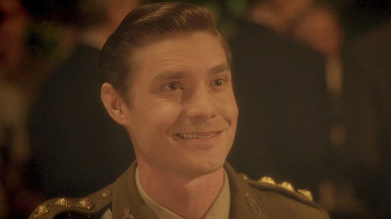 Max Brown as Michael Carter, with slicked back brown hair and a 1940s-era British army uniform.