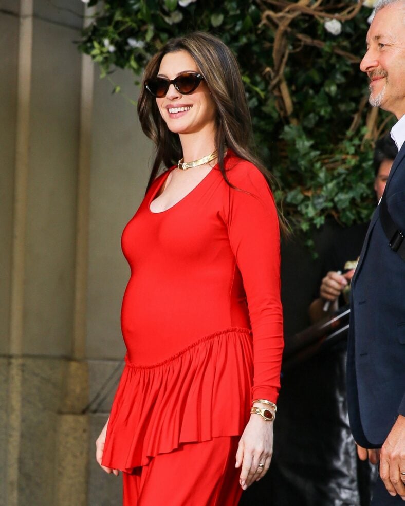 Anne Hathaway wears red while out promoting The Odyssey