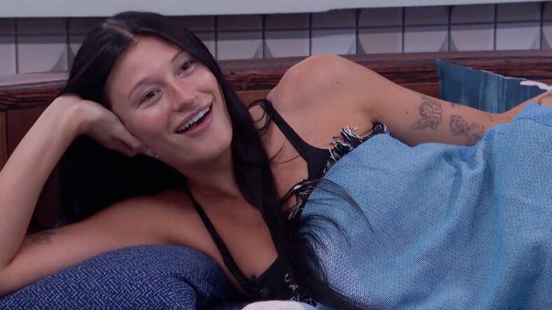 Ashley Trail during Big Brother 28, laying on her side smiling